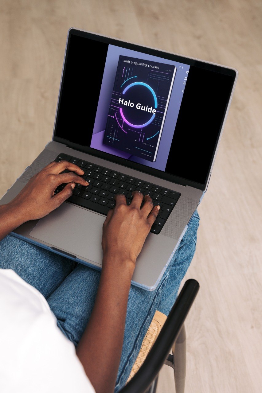 Person using a laptop with a 'Halo Guide' on the screen, sitting on a bed.